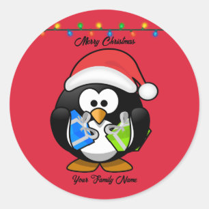 Pegatina Redonda Pingüino de fondo rojo con regalos de Navidad