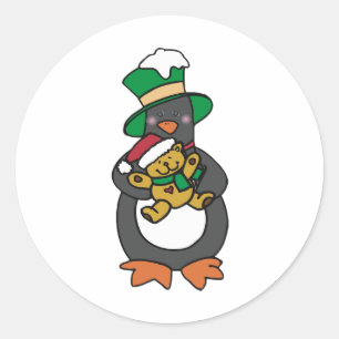 Pegatina Redonda Pingüino irlandés sosteniendo un oso de peluche de