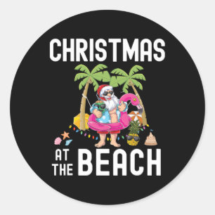 Pegatina Redonda Santa palmera surfista Navidad de verano en la pla