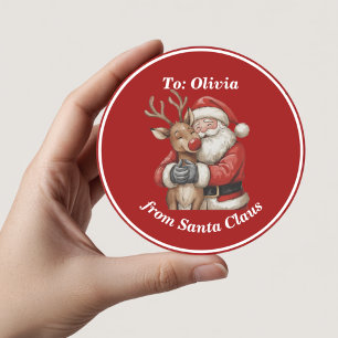 Pegatina Redonda Santa y los renos abrazan a los Navidades rojos Pe