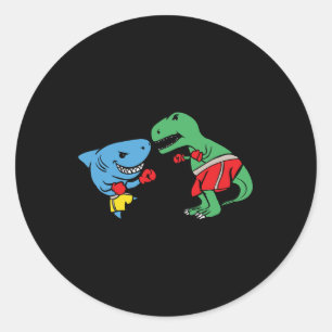 Pegatina Redonda Tiburón golpeando T-rex Dinosaurio Divertido Boxeo