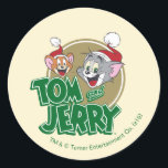 Pegatina Redonda Tom and Jerry Holiday Logo<br><div class="desc">Check out this cute Tom and Jerry logo featuring their smiling faces with festive Santa hats on.</div>
