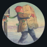 Pegatina Redonda Vintage Christmas, Child with Large Package<br><div class="desc">Ilustracion de la Vintage. Imagen de feriado navideño con un muchacho que cargaba un paquete con regalos y regalos de Navidad del buzón a través de la nieve en invierno. El niño lleva un gorra rojo y una bufanda verde.</div>