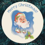Pegatina Redonda Vintage Christmas, Retro Jolly Santa Claus<br><div class="desc">Vintage illustration Christmas holiday design featuring a floating Santa Claus face over a snow covered village. Ribbon with stars and Christmas holly frame the scene.</div>