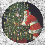 Pegatina Redonda Vintage Christmas, Santa Claus with Presents<br><div class="desc">Vintage illustration Merry Christmas holiday design featuring a jolly Santa Claus lighting candles on a decorated Christmas tree with wrapped gifts and presents underneath. Season's Greetings and Happy Holidays!!  Ho,  ho,  ho!</div>