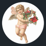 Pegatina Redonda Vintage Christmas, Victorian Angel con Floral Wrea<br><div class="desc">Imagen de fiesta religiosa de Navidades de ilustracion de época con un cherúb con alas sosteniendo una corona floral hecha de flores,  bayas y otras flores rojas. Una antigua morada victoriana cortada para ayudar a celebrar las festividades esta temporada.</div>