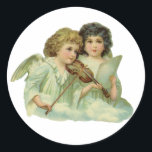 Pegatina Redonda Vintage Christmas, Victorian Angels Music Violin<br><div class="desc">Navidades de ilustracion vintage celebran una imagen religiosa con dos ángeles; se corta la vida victoriana antigua. Un ángel está tocando un instrumento musical de cuerdas, el violín, y el otro ángel musical sostiene partitura de papel. Que este hermoso diseño angélico te ayude a celebrar las fiestas de esta temporada....</div>