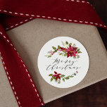 Pegatina Redonda Watercolor Poinsettia Merry Christmas Script<br><div class="desc">Elegantes stickers de Navidad con "Feliz Navidad" mostrados en un hermoso guión de caligrafía rodeado de ramos de poinsettias rojas, flores blancas y frondosas hojas verdes. Los pegatinas de puntiaguería son perfectos para sellar sobres de vacaciones, bolsas de fiestas de vacaciones y hacer el accesorio perfecto para su envoltura de...</div>