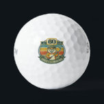 Pelotas De Golf Funny 60th Birthday<br><div class="desc">Celebrate turning 60 with a laugh on the golf course! These funny 60th birthday golf balls feature a goofy “Still Swinging After All These Years” design with 60 printed right on the ball. Perfect for golfers who know that age is just a number—especially when the swing is still going strong....</div>