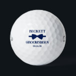 Pelotas De Golf Groomsman Blue Bow Tie<br><div class="desc">These golf balls are a great favor for the groomsman in your wedding. They feature a blue bow tie with the groomsman's name above it in a modern CAP font and the word Groomsman along with the wedding date below. They'd be great for a bachelor party or weekend. The job...</div>