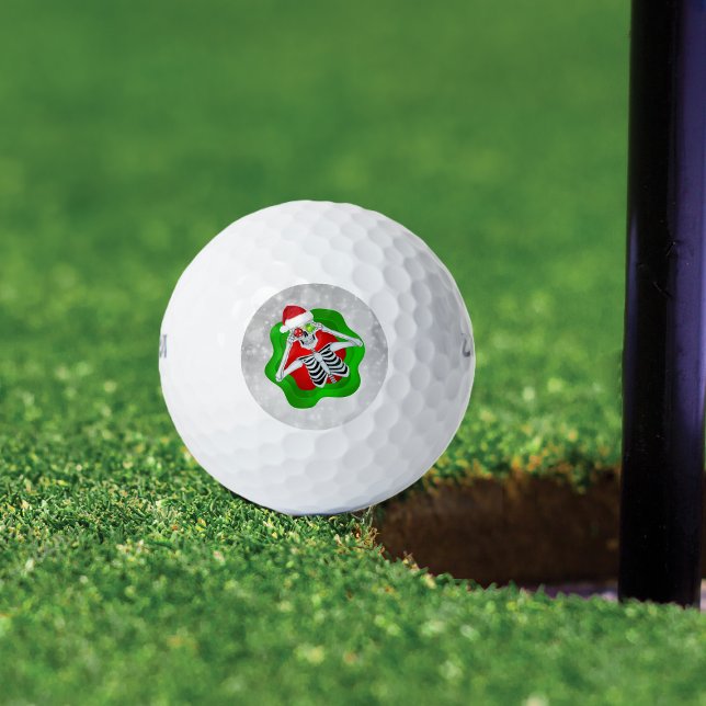 Pelotas De Golf Navidades divertidos esqueletan ornamentos con ojo (fun Christmas Skeleton with Ornament eyeballs Santa hat in red and green spatter on golf balls.)