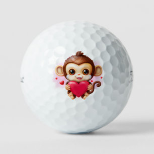 Pelotas De Golf Un mono bebé adorable sostiene un corazón rojo