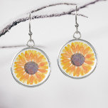 Pendientes Girasol<br><div class="desc">Estos aretes florales están decorados con un girasol acuático amarillo. Acuarela original © Michele Davies.</div>