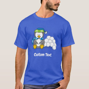 Pequeño pingüino sentado con una camiseta con bola