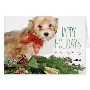 Perrito del navidad con el arco rojo