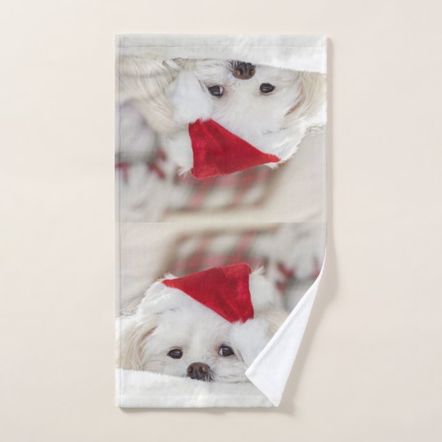 Perro blanco lindo en un Gorra de Navidades rojos (Toalla de mano)