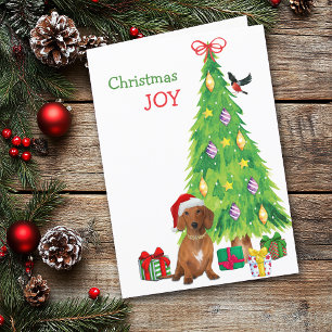 Perro diachshund de Santa Roja y árbol de Navidad