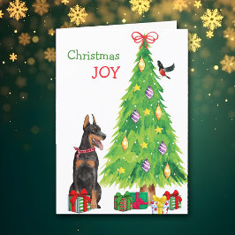 Perro Doberman Pinscher y árbol de Navidad