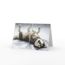 Perro Husky Siberiano de Navidad haciendo un ángel