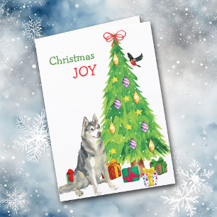 Perro Husky Siberiano y árbol de Navidad