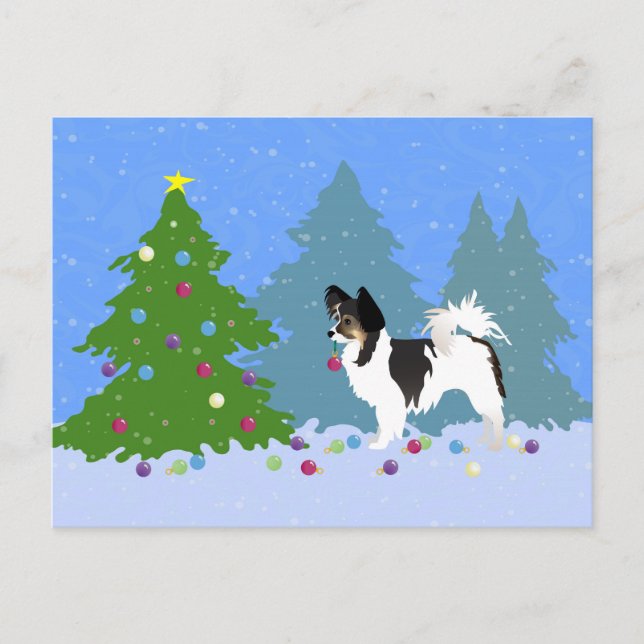 Perro Papillon decorando árbol de Navidad en bosqu (Anverso)