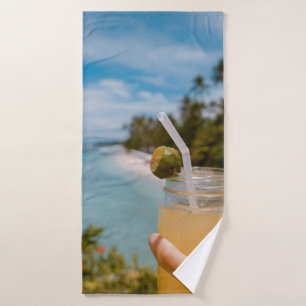 Persona sosteniendo un frasco de albañil con jugo 