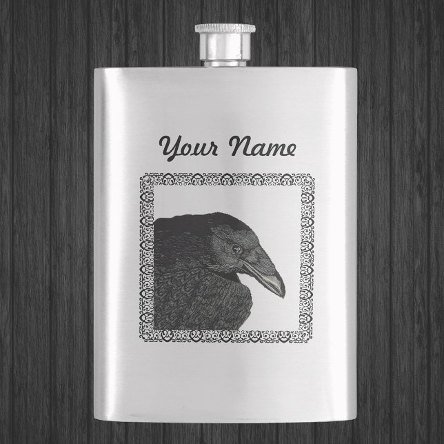 Petaca Cuervo Negro Espantoso Cara de Cuervo (Head shoulders of Gothic black crow in ornate black frame on silver drinking flask.)