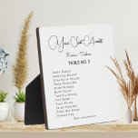Placa Expositora Boda de la mesa de su asiento de espera<br><div class="desc">Añade un toque personal a la recepción de tu boda con esta bonita placa de mesa. Esta placa muestra las palabras "Su asiento espera" en un hermoso guión, junto con su nombre y fecha de boda. Incluye una facilidad para una visualización sencilla en las mesas o en cualquier otro lugar...</div>