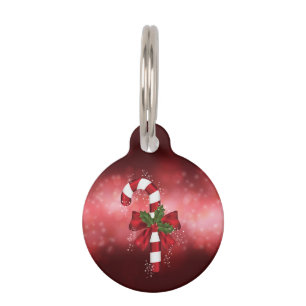 Placa Para Mascotas Caramelo Rojo de Navidad Sobre un Fondo Rojo Bokeh