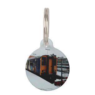 Placa Para Mascotas Tren amarillo y azul en la nieve