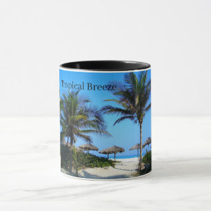 Playa de arena con palmeras y una taza con vistas 