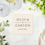 Posavasos Cuadrado De Papel Monograma moderno de boda en marfil y negro<br><div class="desc">Coasters de boda elegantes con los nombres de la pareja en tipografía negra en negrita con un ampersand de escritura elegante en un cálido fondo de marfil. La fecha de la boda completa este diseño de monograma moderno y pulido. Un acento sofisticado para la mesa de recepción o recuerdo con...</div>