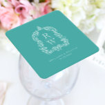 Posavasos Cuadrado De Papel Vintage Monogram Crest Names Turquoise Wedding<br><div class="desc">This elegant design features an ornate,  regency vintage-inspired crest of acanthus leaves framing two monogram initials in open serif font,  stacked vertically and separated by a thin horizontal line. Add the couple's names and wedding date below. The design and text are in white on a turquoise background.</div>