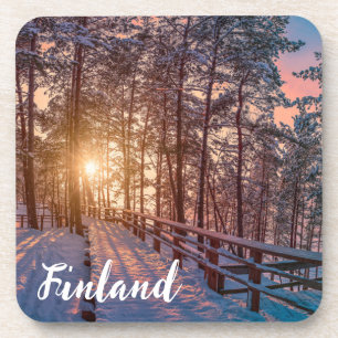 Posavasos Sunset in snowy pine forest with sun ray