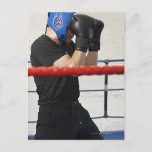 Postal Boxer cubriendo su cara en el anillo