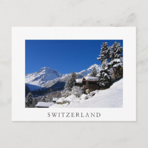 Postal Cabañas de troncos cubiertas de nieve en Suiza