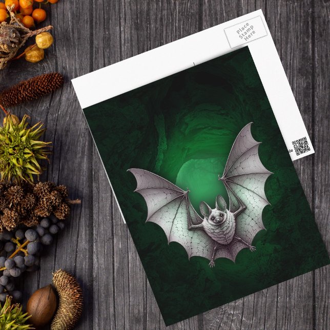 Postal Cueva Verde Brillante Murciélago Blanco Espeluznan (Eerie flying white bat green glowing cave on black Halloween postcard.)