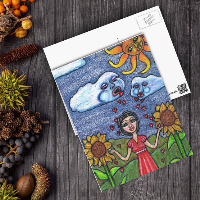 Postal El amor te hará crecer (Clouds raining red hearts down on lady in sunflowers with orange sun looking on postcard.)