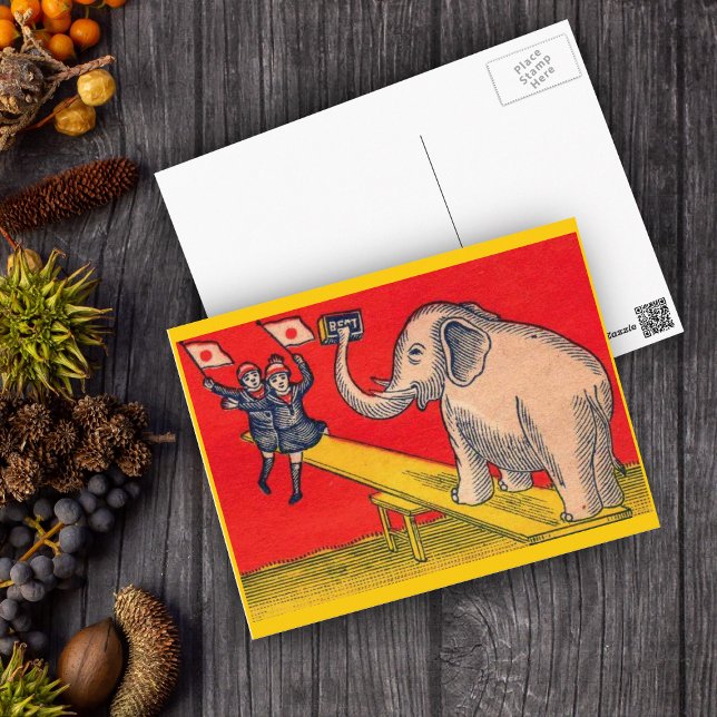 Postal Elefante en la sierra con niños con cámara (Elephant on seesaw with children waving Japanese flags on red and yellow postcard.)
