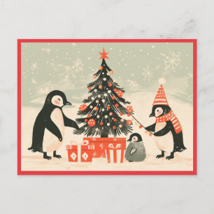 Postal Familia de pingüinos decorando el árbol de Navidad