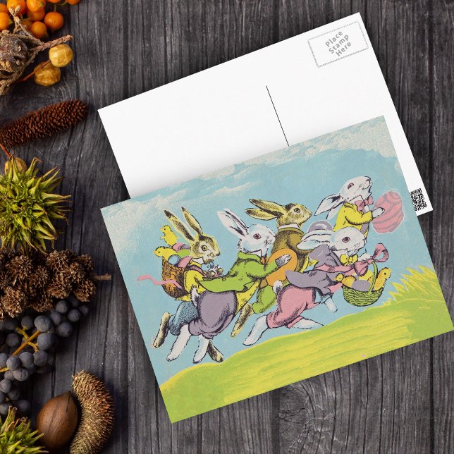 Postal Festiva Easter Running Pastel Rabbits (Group White Easter Rabbits in grass Blue sky Baskets Eggs on Easter holiday postcard.)