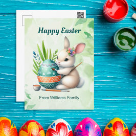 Postal Festiva Feliz Pascua, dulce conejita pintando un huevo de