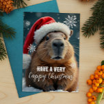 Postal Festiva Navidades muy hábiles Navidades del Capibara<br><div class="desc">Envíen a algunos Navidades de Capy a aclamar esta temporada navideña con esta graciosa tarjeta de Navidades en la que aparece el animal chill favorito de todos - el capibara! Decorada con un sombrero festivo de Papá Noel y rodeada de copos de nieve, esta carta aporta una dosis extra de...</div>