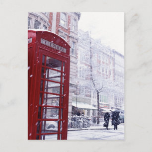 Postal Festiva Nieve cayendo en la caja del teléfono rojo