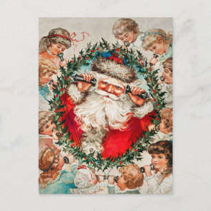 Postal Festiva Papá Noel en los teléfonos de cuerdas escuchando a