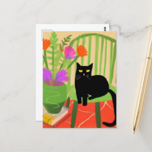 Postal Gato negro adorable en una silla verde