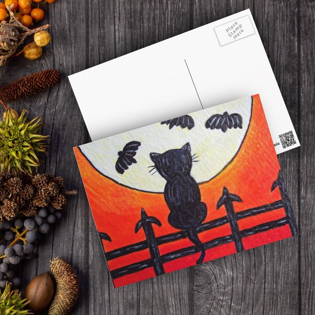 Postal Gato sobre una cerca en los murciélagos de la luna (Silhouette black cat on fence watching fly bats in full moon on orange Halloween postcard.)