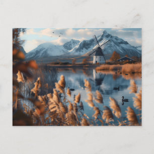 Postal Molino de viento en un lago con paisaje montañoso