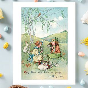 Postal Niños de la época con conejos de Pascua y huevos