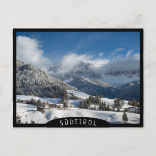 Postal Pequeño pueblo con montañas Dolomitas en la nieve